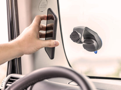 Off road car mount with wireless charging head attached to windscreen with iPhone