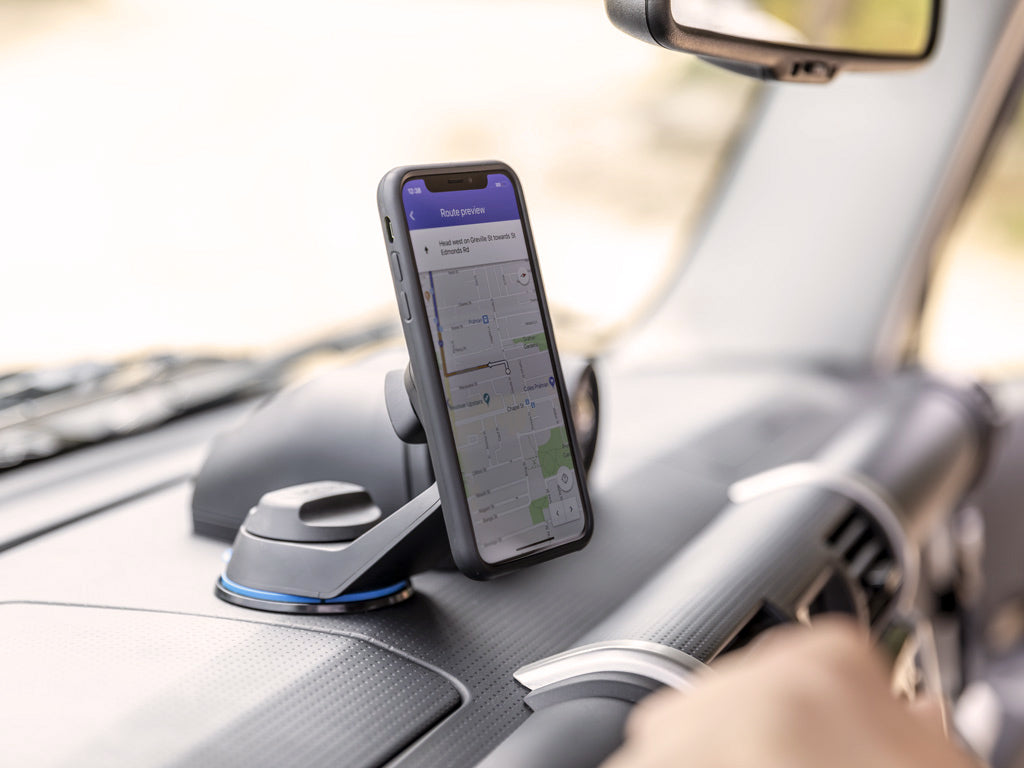 Off road car mount with wireless charging head attached to windscreen with iPhone