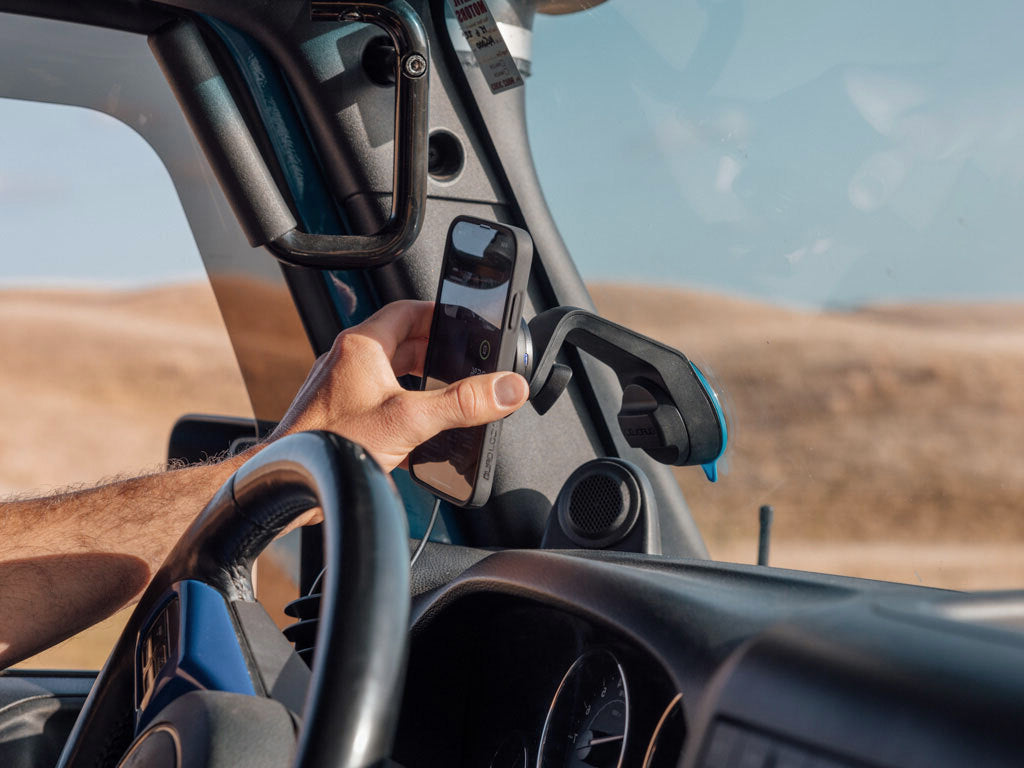 Off road car mount with wireless charging head attached to windscreen with Samsung Galaxy