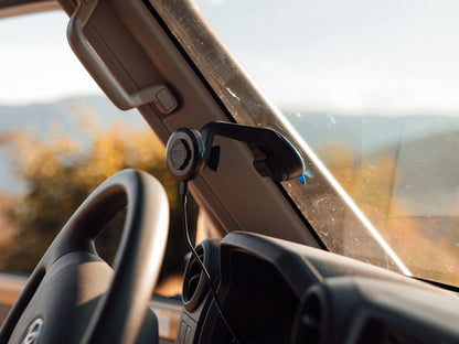 Off road car mount with wireless charging head attached to windscreen