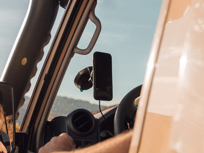 Off road car mount with wireless charging head attached to windscreen with iPhone