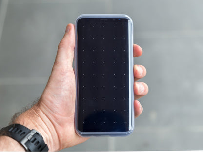 samsung galaxy with quad lock case and poncho held in hand