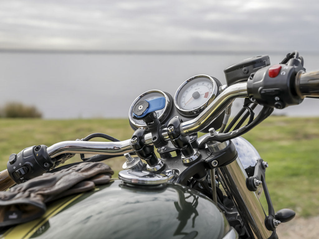 triumph with quad lock handlebar mount and moto knuckle adaptor