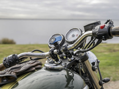 triumph bike with quad lock handlebar mount and motorcycle knuckle adaptor