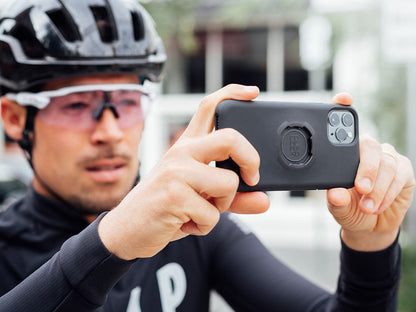 bike rider taking photo with quad lock case and iphone 11 pro