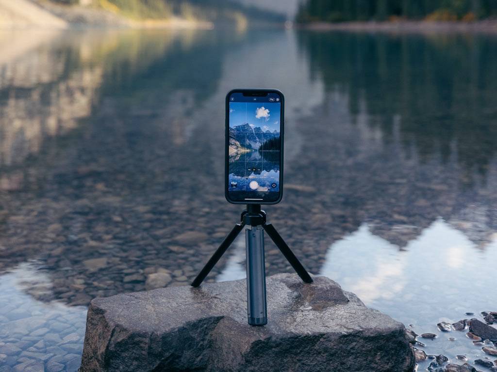 Quad Lock tripod adaptor with phone and tripod taking photo of mountains